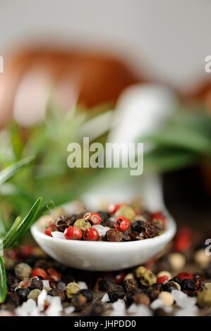 peppercorn in a spoon on wooden background Stock Photo