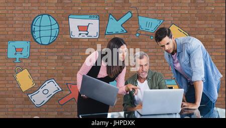 Digital composite of Business people at a desk looking at a computer against brick wall with graphics Stock Photo