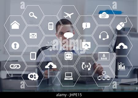 Digital composite of Icons against office background Stock Photo