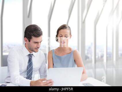 Digital composite of Business people at a desk looking at a computer Stock Photo