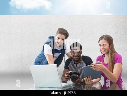 Digital composite of Group of people on laptop with camera in front of grey background with sky Stock Photo