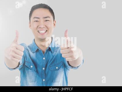 Digital composite of Portrait of Man giving thumbs up with grey background Stock Photo