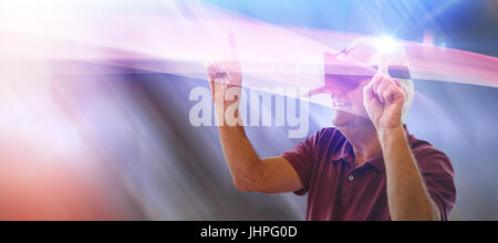 Happy senior man dancing while using virtual reality glasses against table and empty chairs in office Stock Photo