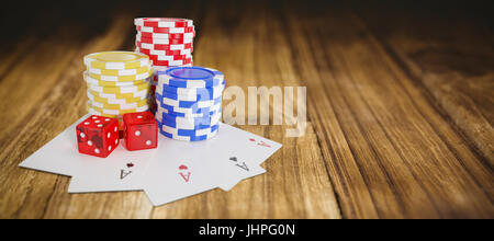 Tilt image of casino tokens with playing cards and dice against wooden table Stock Photo