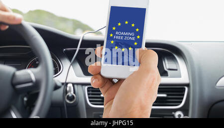 Male hand holding a smartphone against screen of satellite navigation system Stock Photo