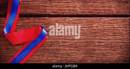 Close-up of red and blue ribbon on wooden table Stock Photo