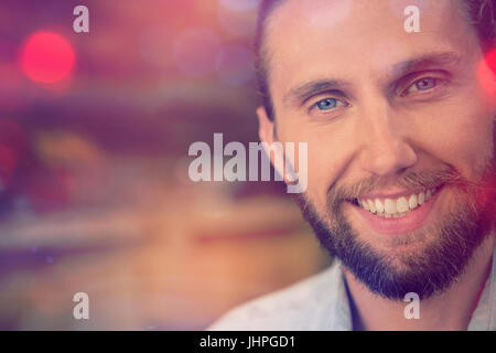Close up portrait of young man smiling at cafe Stock Photo