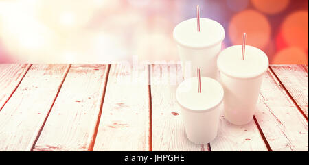 White cups over white background against glowing background Stock Photo