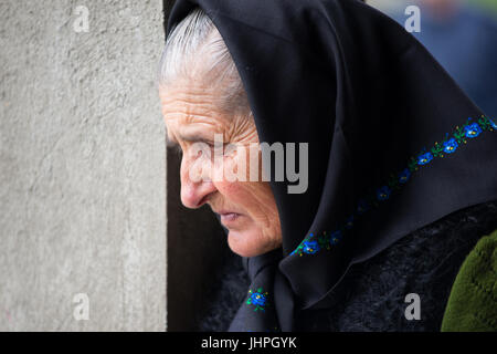 An old woman with sad expression during Easter mass, village of Breb, district of Maramures,romania Stock Photo