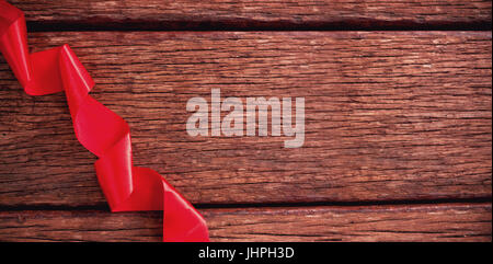 Close-up of red ribbon on wooden table Stock Photo