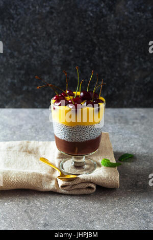 Layered chocolate dessert in glass jars Stock Photo