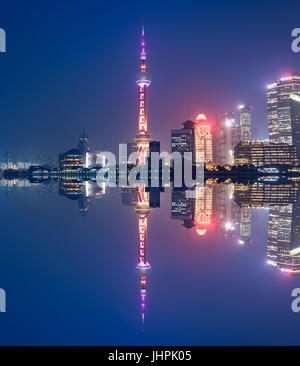 Aerial panoramic view over a big modern city by night. Shanghai, China. Nighttime skyline with illuminated skyscrapers