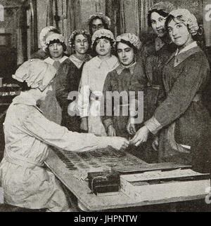 Women munitions factory workers purchasing tickets for canteen refreshments Stock Photo