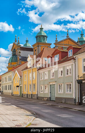 One of the streets in the Swedish town of Kalmar close to the cathedral which can be seen in the background behind the houses. Stock Photo