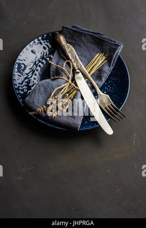 Table setting with dried lavender flowers in vintage style on dark table Stock Photo