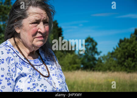 Windswept elderly woman looking anxious about about the future. Stock Photo