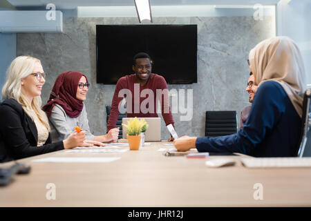 Business meeting in a modern office, multiracional colleagues collaborating together. Stock Photo