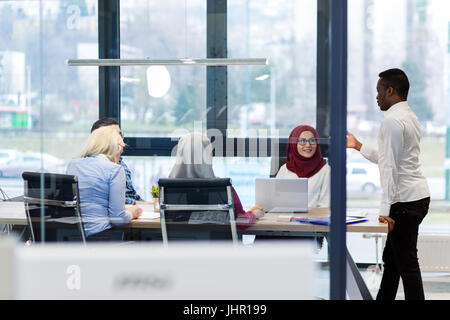 Back view of co-workers writing documents using laptops at workplace in office. Copyspace. Stock Photo
