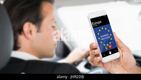 Cropped image of businesswoman holding smart phone against businessman in the drivers seat Stock Photo