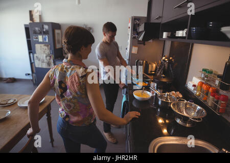 Couple preparing food in kitchen at home Stock Photo