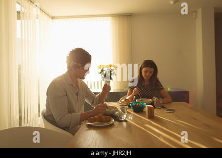 Couple having breakfast together at home Stock Photo