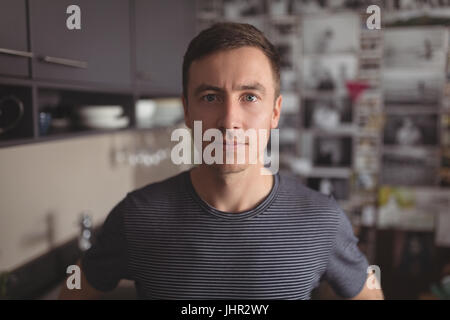 Portrait of man standing in kitchen at home Stock Photo