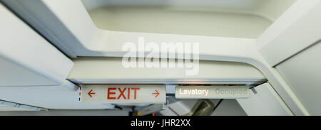 Close-up of exit sign board in aircraft Stock Photo