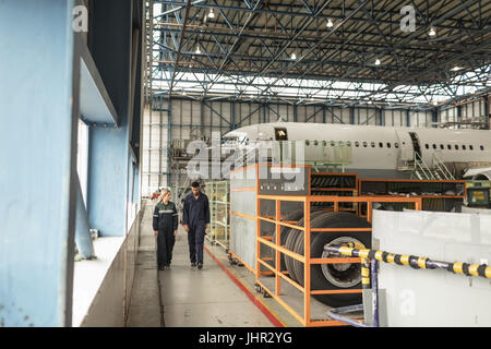 Aircraft maintenance engineers interacting with each other at airlines maintenance facility Stock Photo