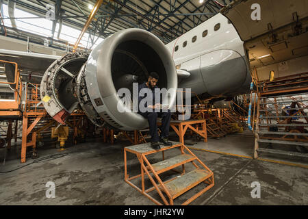 Aircraft maintenance engineer using digital tablet at airlines maintenance facility Stock Photo