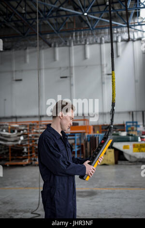 Maintenance engineer operating a control panel at airlines maintenance facility Stock Photo