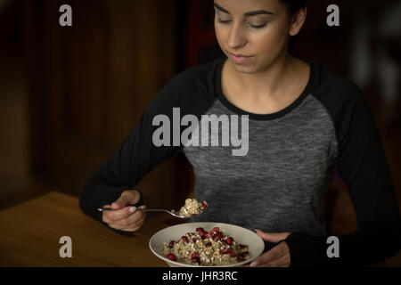 Young Woman having breakfast at home Stock Photo
