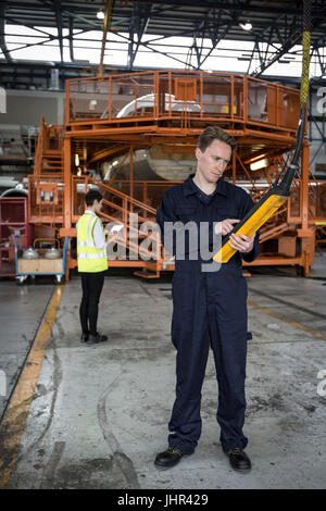 Maintenance engineer operating a control panel at airlines maintenance facility Stock Photo