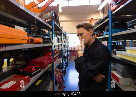 Male aircraft maintenance engineer examining various work tool at airlines maintenance facility Stock Photo