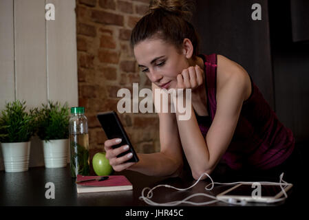 Beautiful woman using mobile phone at home Stock Photo