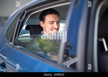 Smiling man sitting in car Stock Photo