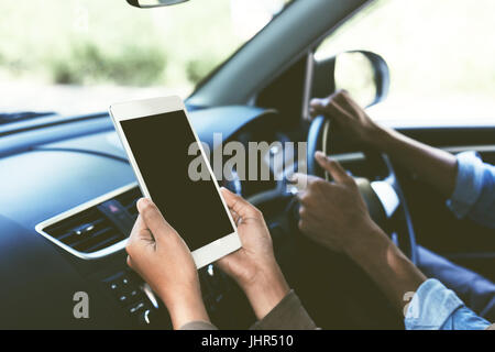 selective focus on hand hold digital tablet blank secreen display inside car Stock Photo