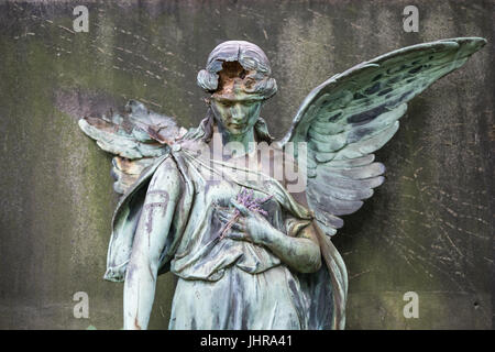 damaged sculpture of a female angel statue  on cemetery Stock Photo
