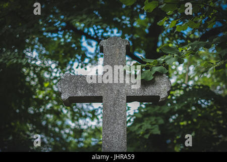 stone cross on grave, gravestone on cemetery Stock Photo