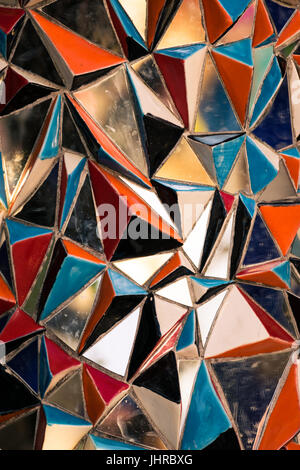 Detail of a wall made of triangular pieces of colored glass. Stock Photo