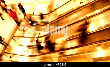 London, UK - October 4, 2012: London commuters using an escalator during the evening rush hour at Liverpool St Station. Long exposure is used to highl Stock Photo