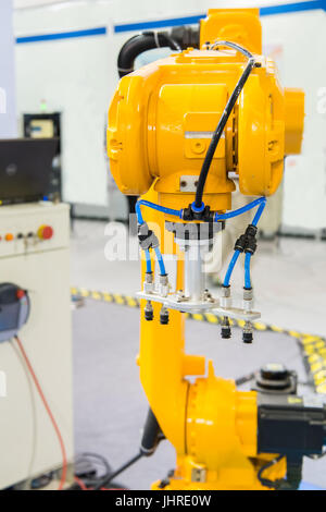 Industrial robot with vacuum suckers with conveyor in manufacture factory,Smart factory industry 4.0 concept. Stock Photo