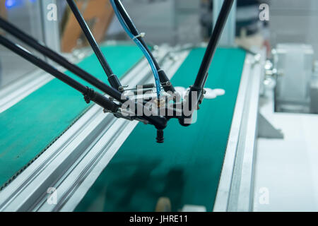 Industrial robot with vacuum suckers with conveyor in manufacture factory,Smart factory industry 4.0 concept. Stock Photo