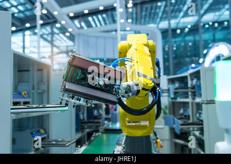 Industrial robot with vacuum suckers with conveyor in manufacture factory,Smart factory industry 4.0 concept. Stock Photo