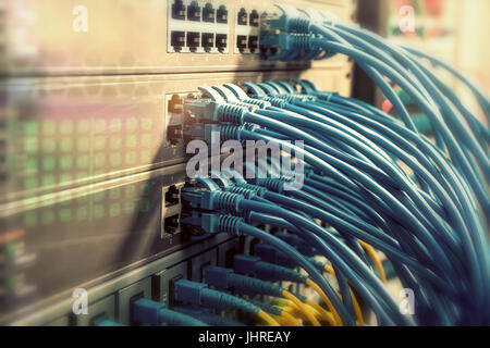 Network cables in switch and firewall in cloud computing data center server rack Stock Photo