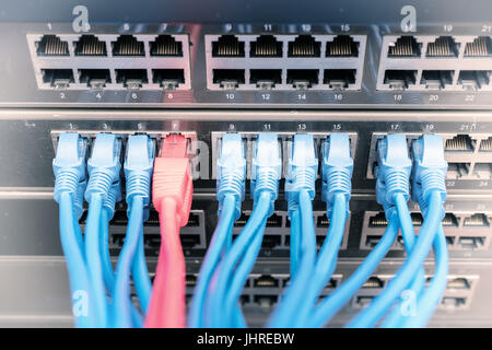 Network cables in switch and firewall in cloud computing data center server rack Stock Photo