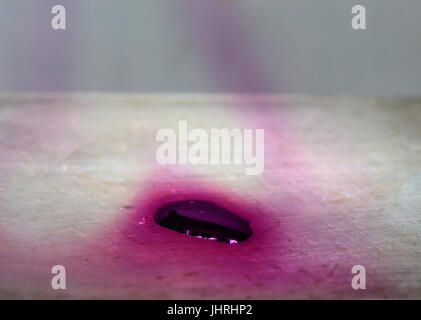 Iodine evaporates on a hot plate, causing ghostly violet vapors to rise from the melt. Stock Photo