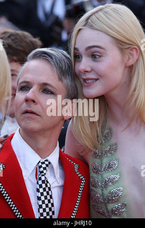 John Cameron Mitchell and Elle Fanning depart after the How To Talk To Girls At Parties screening during the 70th annual Cannes Film Festival at Palais des Festivals on May 21, 2017 in Cannes, France. Stock Photo