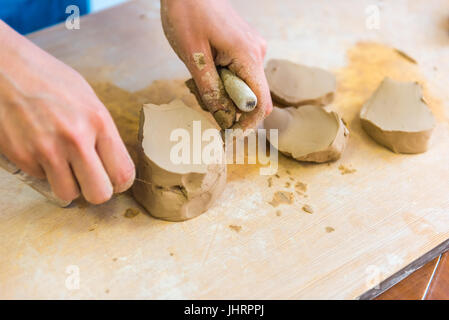 Pottering - creating a clay cup in process. Shot with a small GRIP Stock Photo