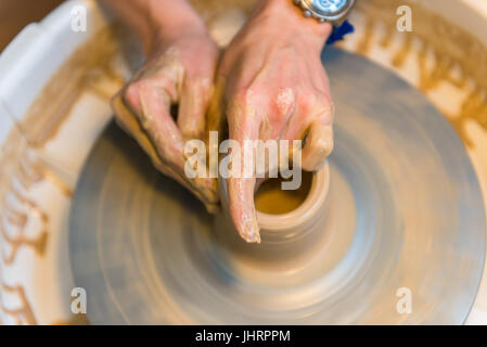 Pottering - creating a clay cup in process. Shot with a small GRIP Stock Photo