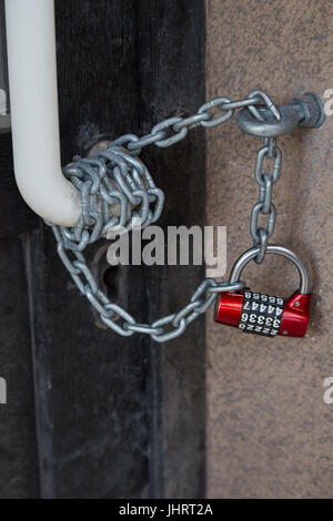 Door closed on the chain with a coded lock Stock Photo